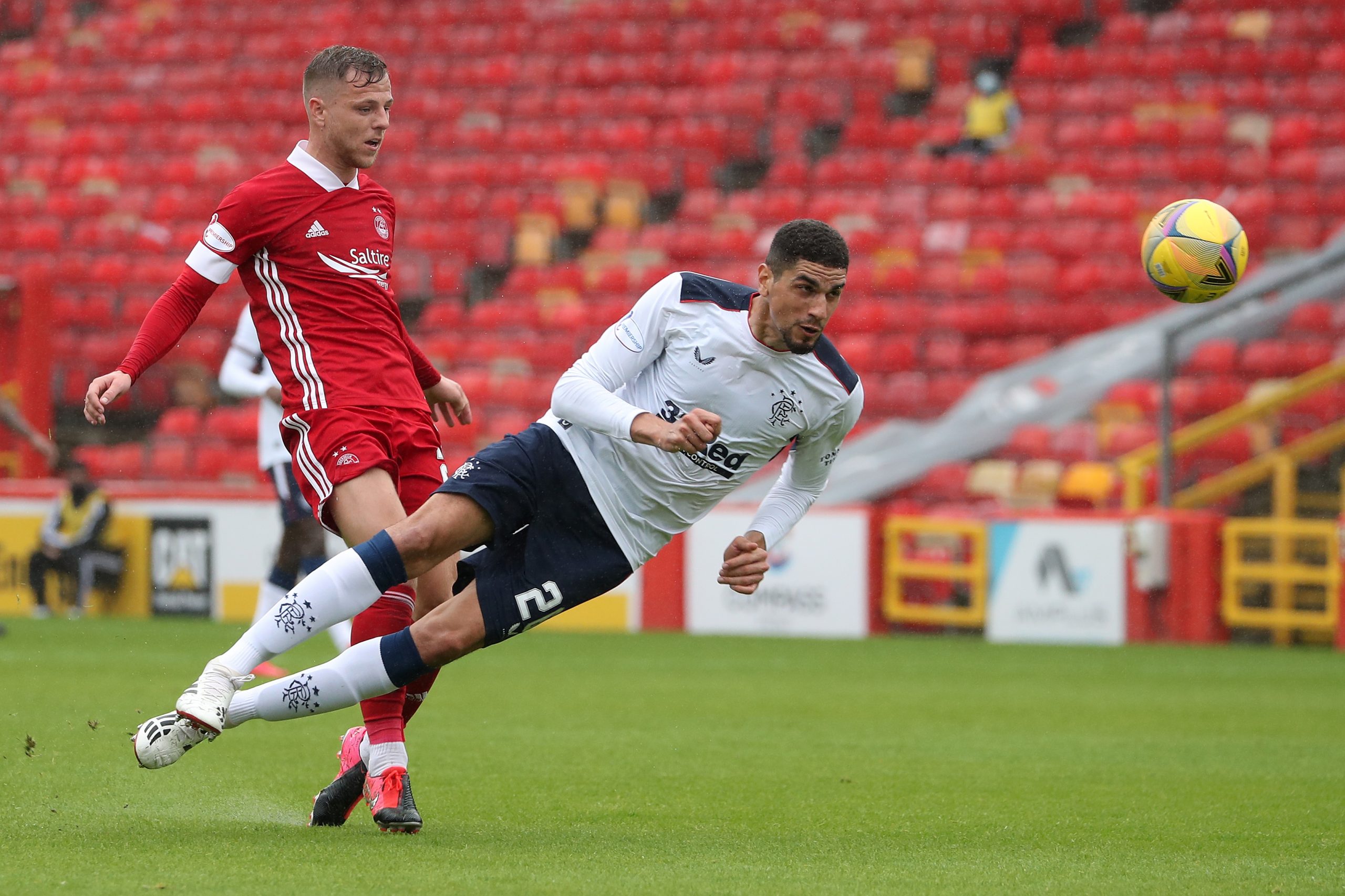 Aberdeen's Bruce Anderson (L) vies with Rangers' Leon Balogun during the Scottish Premier League football match between Aberdeen and Rangers at Pittodrie Stadium in Aberdeen, northeast Scotland, on August 1, 2020. (Photo by Andrew Milligan / POOL / AFP) (Photo by ANDREW MILLIGAN/POOL/AFP via Getty Images)