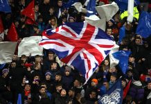 GLASGOW, SCOTLAND - MARCH 12: Rangers FC fans wave a union jack flag prior to the UEFA Europa League round of 16 first leg match between Rangers FC and Bayer 04 Leverkusen at Ibrox Stadium on March 12, 2020 in Glasgow, United Kingdom.