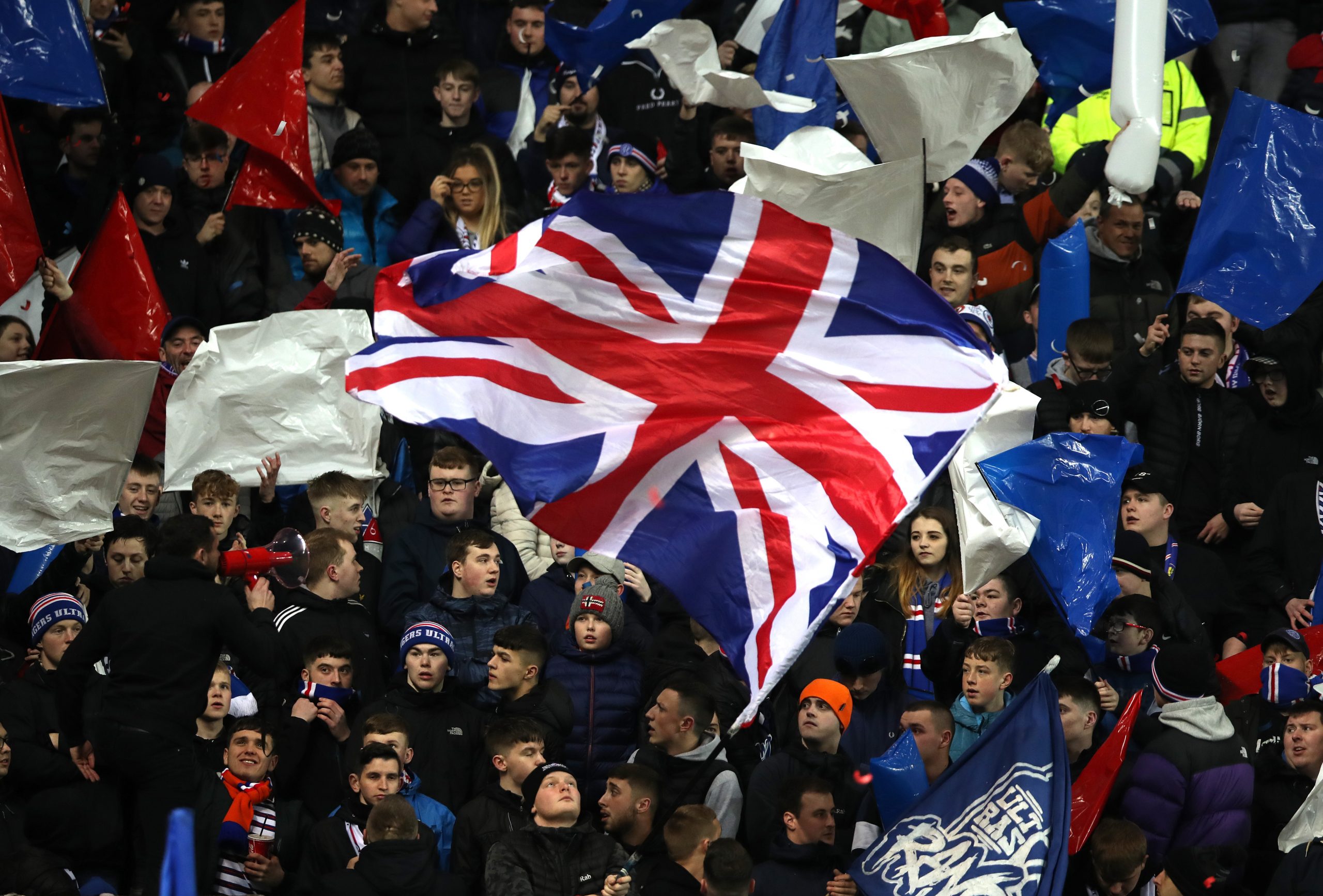 GLASGOW, SCOTLAND - MARCH 12: Rangers FC fans wave a union jack flag prior to the UEFA Europa League round of 16 first leg match between Rangers FC and Bayer 04 Leverkusen at Ibrox Stadium on March 12, 2020 in Glasgow, United Kingdom.