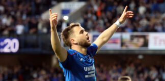 Nico Raskin in action for Rangers during a match at Ibrox, wearing the club’s blue home kit and focused on play.