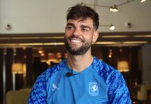 SLAMMED: Press attacks Rangers and Scottish football with former Ibrox defender Robin Pröpper smiles during an interview while wearing an FC Twente training top, seated indoors with warm lighting in the background.