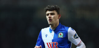 Owen Beck of Blackburn Rovers in action during a Sky Bet Championship match, wearing the club's blue and white kit.