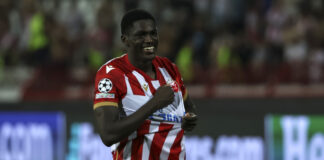 Nasser Djiga smiling in Red Star Belgrade kit during a Champions League fixture