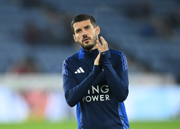 Conor Coady clapping during warm-up in Leicester City training gear before a Premier League match.
