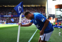Cyriel Dessers celebrating a goal at Ibrox in Rangers kit during ongoing transfer speculation.