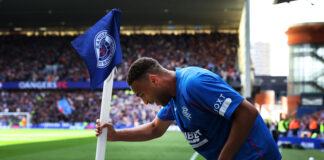 Cyriel Dessers celebrating a goal at Ibrox in Rangers kit during ongoing transfer speculation.