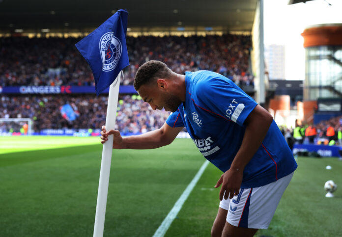 Cyriel Dessers celebrating a goal at Ibrox in Rangers kit during ongoing transfer speculation.
