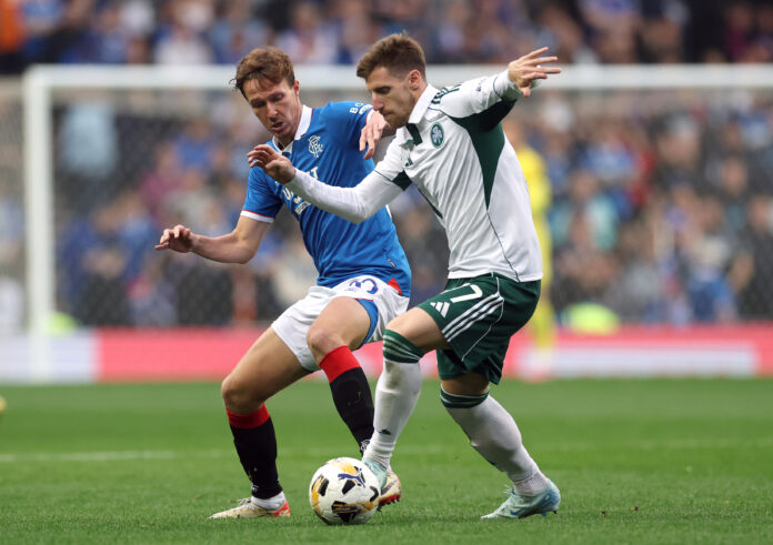 Kieran Dowell of Rangers challenges a Panathinaikos player during the UEFA Champions League second qualifying round first leg at Ibrox.