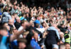 Ex-Rangers Coach Harry Watling Set for Premier League Move with Wolves Rangers fans celebrate passionately in the stands during an Old Firm clash against Celtic.