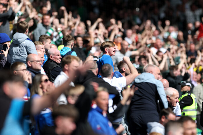 Rangers fans celebrate passionately in the stands during an Old Firm clash against Celtic.