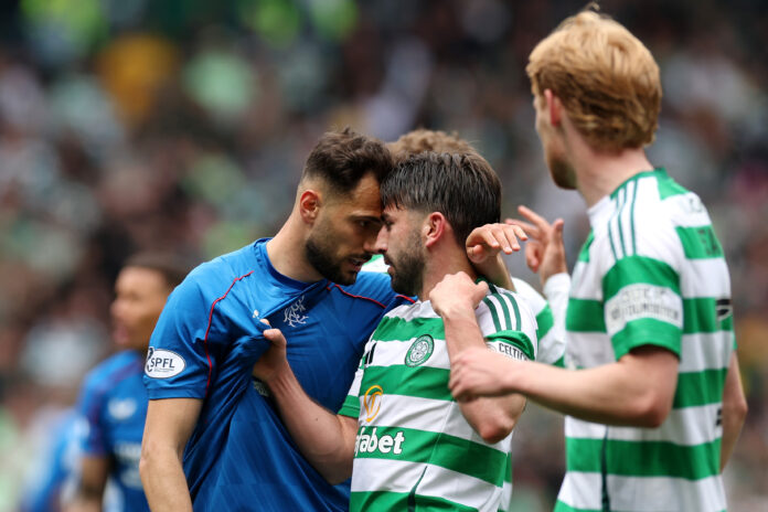 Rangers midfielder Nedim Bajrami clashes face-to-face with a Celtic player during a tense Old Firm derby moment.