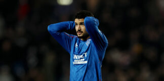 Jefte looks dejected with hands on head during Rangers match at Ibrox.