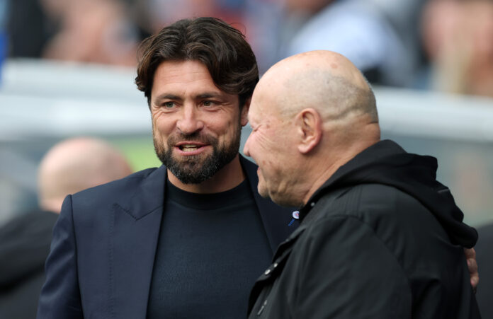 Russell Martin smiles and embraces Miroslav Koubek before kick-off at Ibrox Stadium.