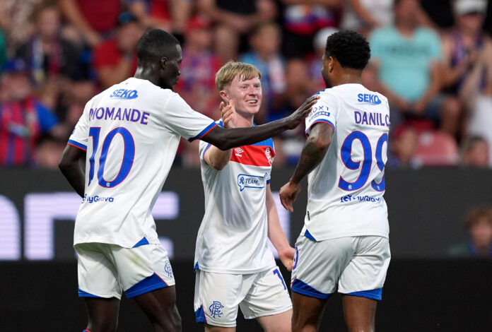 Rangers players Mohamed Diomande, Lyall Cameron, and Danilo celebrate together during a UEFA Champions League qualifying match against Viktoria Plzen.