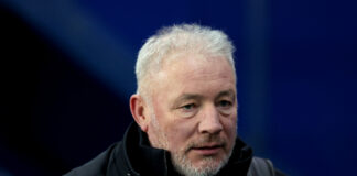 Former Rangers striker and pundit Ally McCoist at a match, wearing a dark jacket.