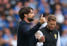 Rangers manager Russell Martin gives a thumbs up on the touchline during a match.