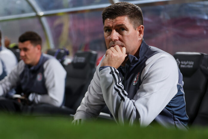 Steven Gerrard sits pensively in the dugout during Al Wehda v Al Ettifaq in the Saudi Pro League.