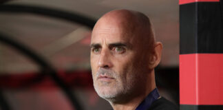 Kevin Muscat looks focused in the dugout during a Shanghai Port AFC Champions League match