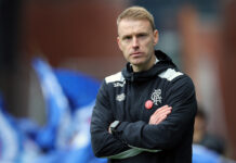 Steven Smith stands on the touchline at Ibrox, arms folded, during his first match as interim Rangers manager.