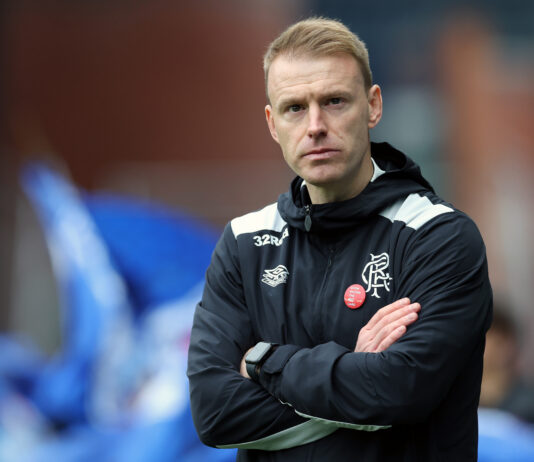 Steven Smith stands on the touchline at Ibrox, arms folded, during his first match as interim Rangers manager.