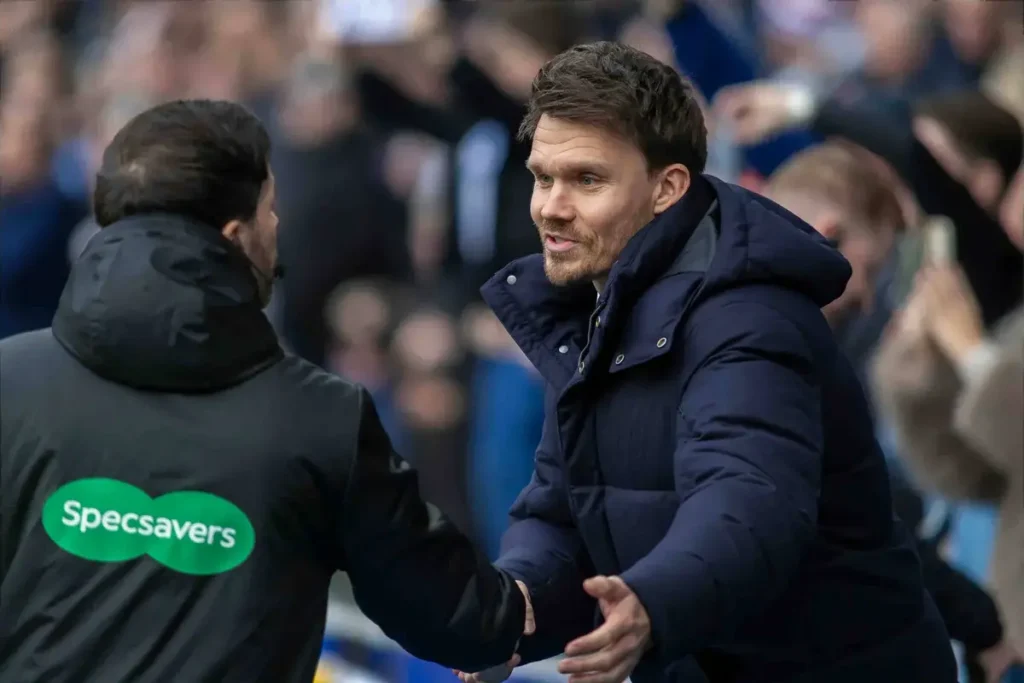 Danny Rohl talks to an assistant referee at Ibrox.