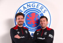 Danny Rohl and Scott Fry pose together in Rangers training gear in front of the Rangers crest at Ibrox after Fry’s appointment as set piece coach.