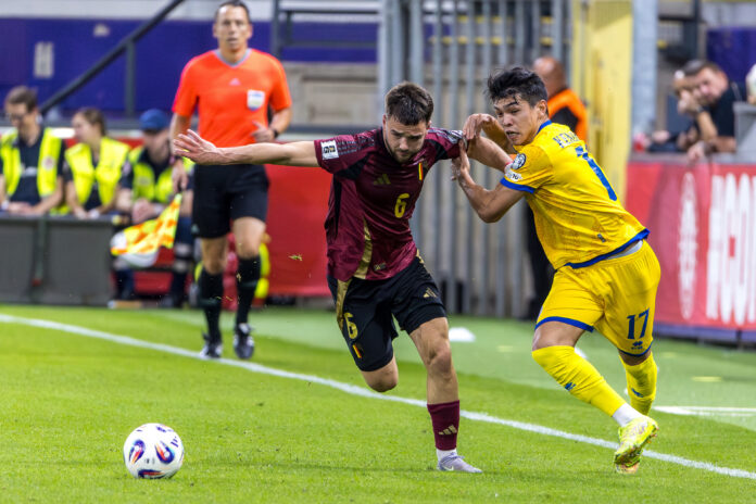 Galymzhan Kenzhebek battles for the ball against a Belgian defender during a World Cup 2026 qualifier in Brussels.