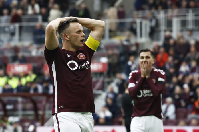 Lawrence Shankland reacts with his hands on his head during a Hearts match as a teammate looks shocked behind him.