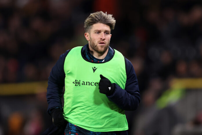 Josh Windass warming up in green training bib before Championship fixture