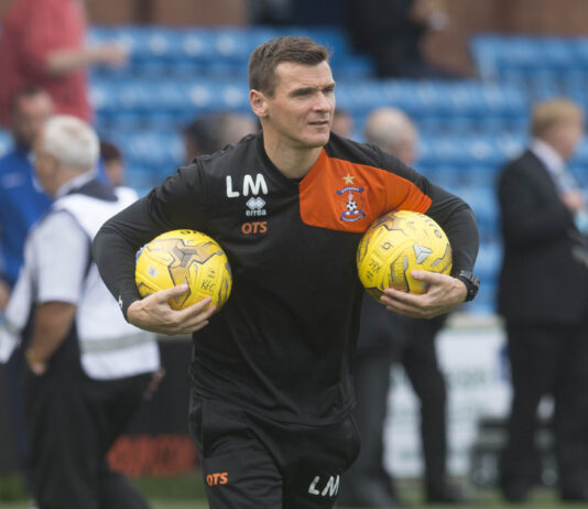 Lee McCulloch in Kilmarnock training kit carrying two yellow footballs during a Scottish Premiership warm-up