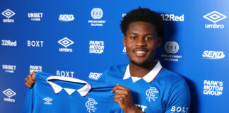 Tochi Chukwuani holds up his Rangers shirt after signing as the Danish midfielder joins the club to strengthen the central midfield