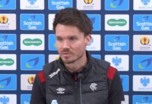 Danny Rohl speaks at a Rangers press conference with Scottish Gas and Barclays branding behind him