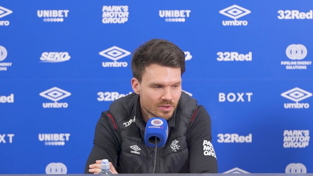Danny Rohl speaking at a Rangers press conference at Ibrox with sponsor backdrop