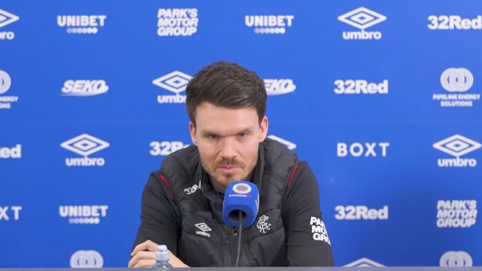 Danny Rohl speaking at a Rangers press conference at Ibrox with sponsor backdrop