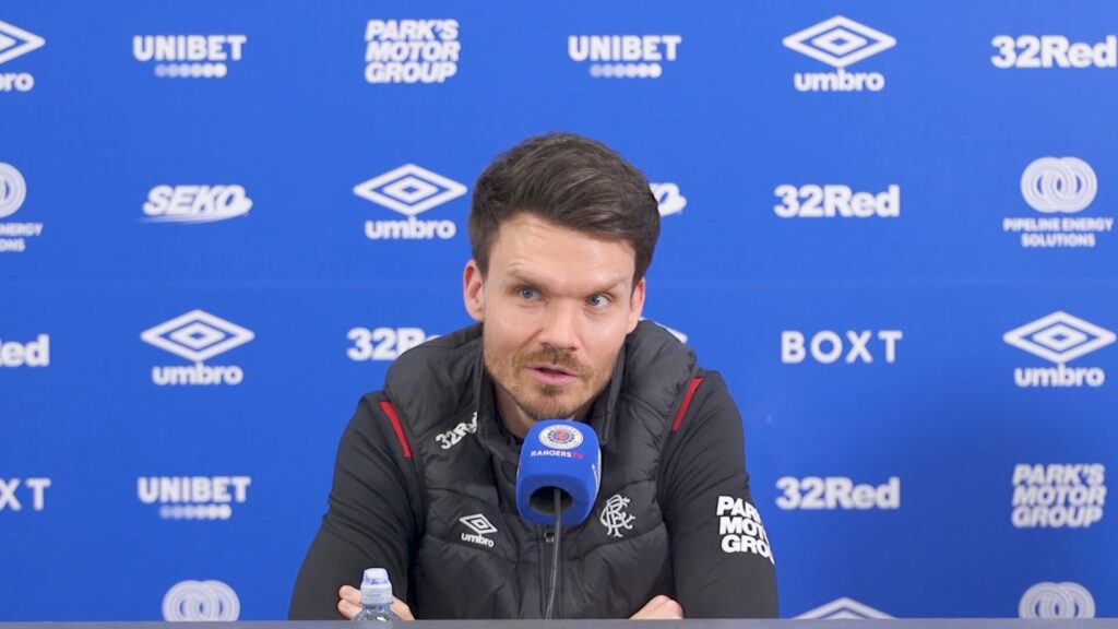 Danny Rohl speaking at a Rangers press conference at Ibrox with sponsor backdrop