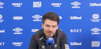 Danny Rohl speaking at a Rangers press conference at Ibrox with sponsor backdrop