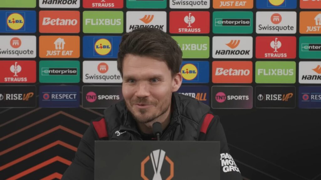 Danny Rohl speaking at a Rangers press conference at Ibrox with sponsor backdrop