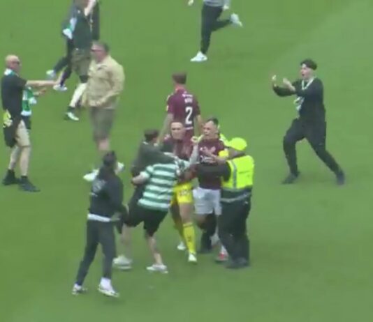 Celtic fans on the pitch confronting Hearts players after Premiership title win at Parkhead