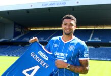 Ben Godfrey poses with the Rangers shirt.