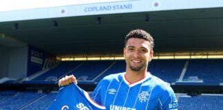Ben Godfrey poses with the Rangers shirt.