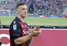 Bologna midfielder Lewis Ferguson applauds amid false figure being reported.