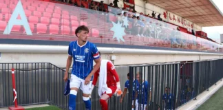 Rangers' captain for the day Dan Neil leads the side out.