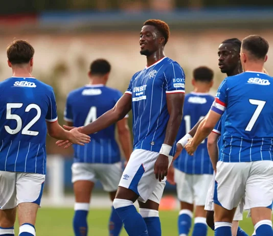 Findlay Curtis and the Rangers players celebrate his goal.