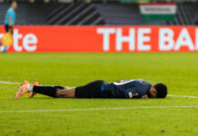 Rangers striker Danilo lies on the turf.