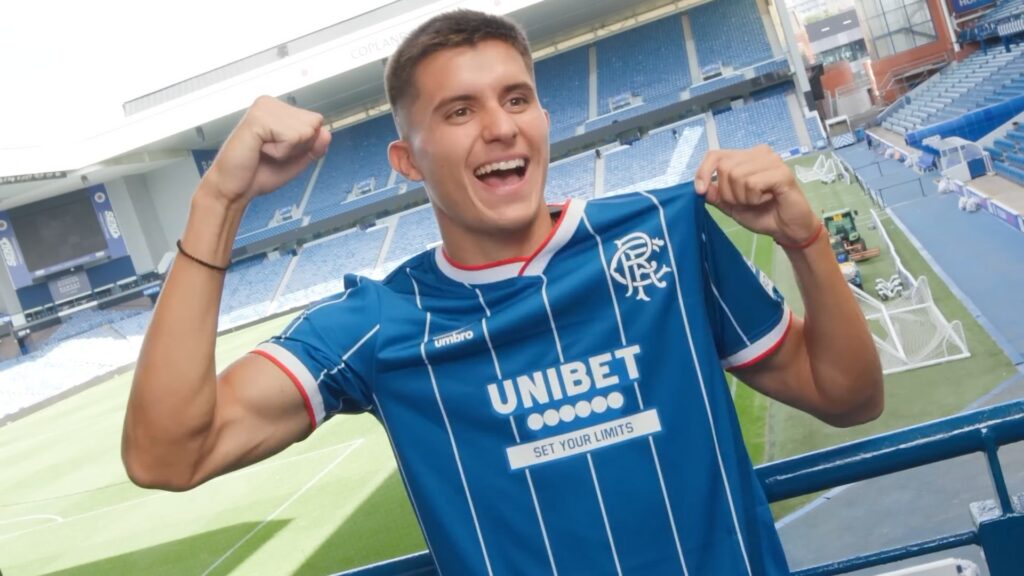 New Rangers signing Vanja Dragojevic poses in the shirt at Ibrox.